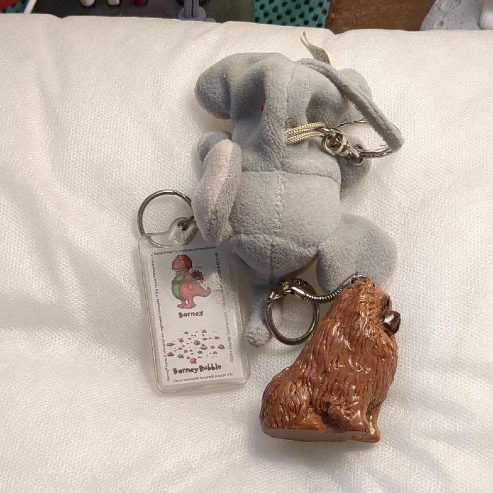 assorted key chains: Gray Elephant Plush, barney, and chow chow.